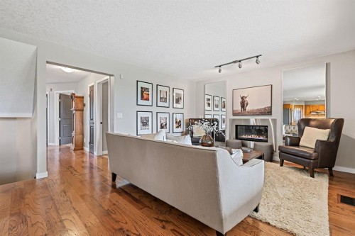 33 Sunset Crescent, Okotoks, AB - Indoor Photo Showing Living Room With Fireplace