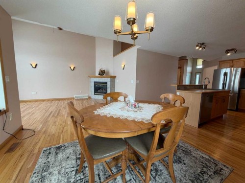 5111 Shannon Drive, Olds, AB - Indoor Photo Showing Dining Room With Fireplace