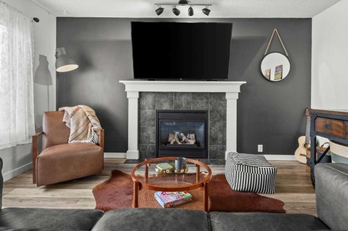 218 Coville Circle Ne, Calgary, AB - Indoor Photo Showing Living Room With Fireplace