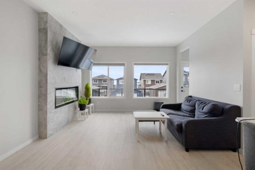22 Edith Manor Nw, Calgary, AB - Indoor Photo Showing Living Room With Fireplace