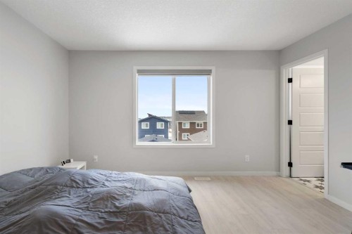 22 Edith Manor Nw, Calgary, AB - Indoor Photo Showing Bedroom