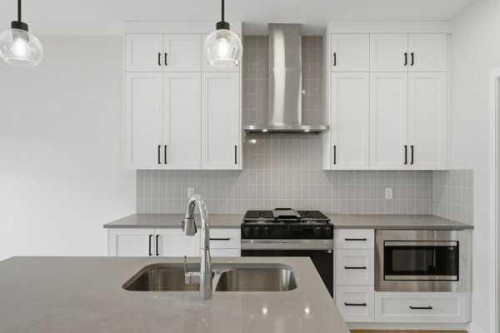 213 Bayview Park Sw, Airdrie, AB - Indoor Photo Showing Kitchen With Double Sink With Upgraded Kitchen