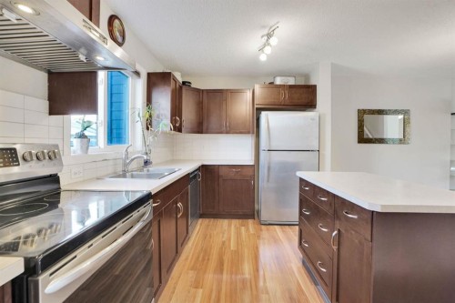 82 Walden Drive Se, Calgary, AB - Indoor Photo Showing Kitchen With Double Sink