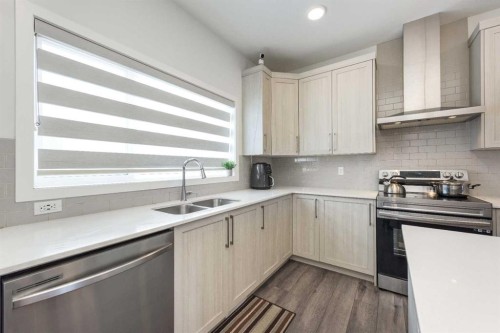 399 Magnolia Drive Se, Calgary, AB - Indoor Photo Showing Kitchen With Double Sink