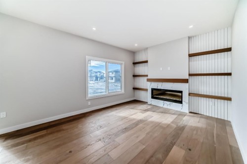 512 Heritage Boulevard, Cochrane, AB - Indoor Photo Showing Living Room With Fireplace