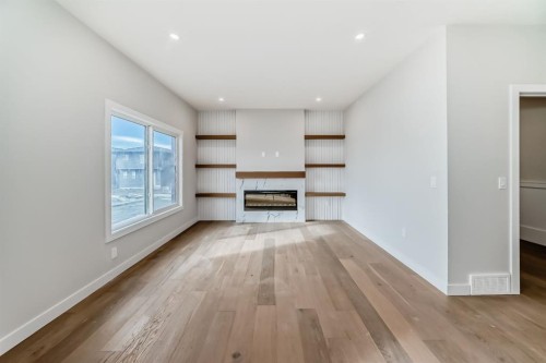 512 Heritage Boulevard, Cochrane, AB - Indoor Photo Showing Living Room With Fireplace
