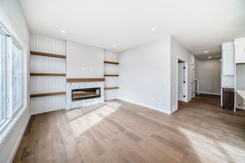 512 Heritage Boulevard, Cochrane, AB - Indoor Photo Showing Living Room With Fireplace