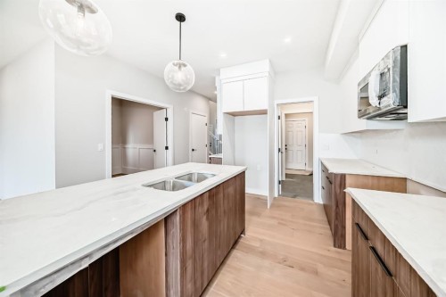 512 Heritage Boulevard, Cochrane, AB - Indoor Photo Showing Kitchen With Double Sink