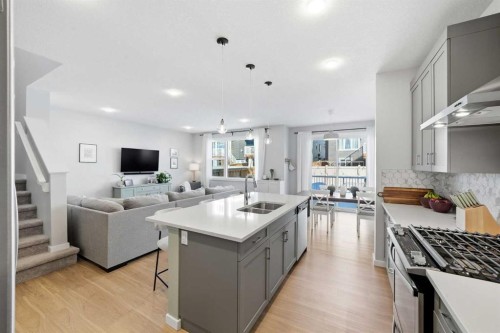 320 Sundown View, Cochrane, AB - Indoor Photo Showing Kitchen With Double Sink With Upgraded Kitchen