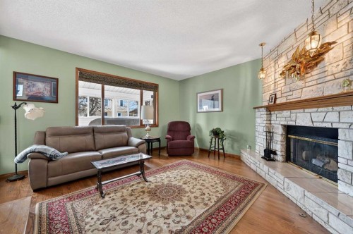 68 Hawkland Circle Nw, Calgary, AB - Indoor Photo Showing Living Room With Fireplace