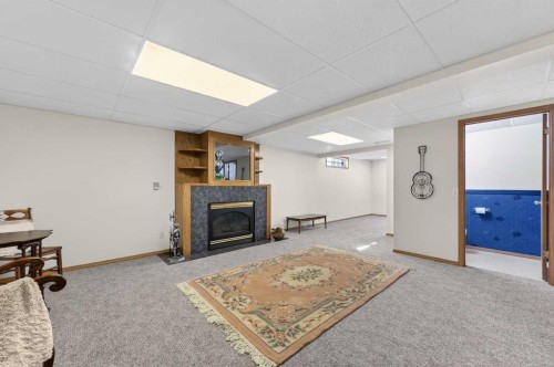 68 Hawkland Circle Nw, Calgary, AB - Indoor Photo Showing Basement With Fireplace