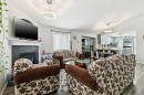 38 Canoe Square Sw, Airdrie, AB  - Indoor Photo Showing Living Room With Fireplace 