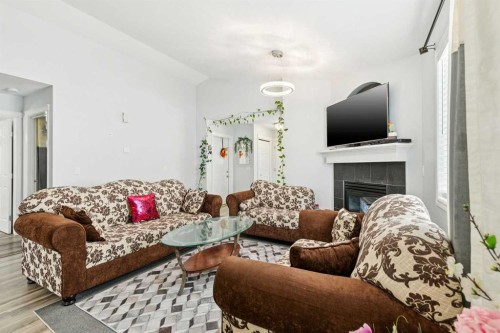 38 Canoe Square Sw, Airdrie, AB - Indoor Photo Showing Living Room With Fireplace