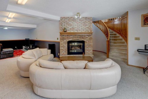 232 Hampshire Place Nw, Calgary, AB - Indoor Photo Showing Living Room With Fireplace