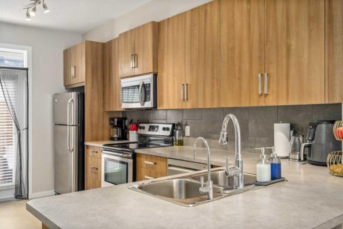 37 New Brighton Point Se, Calgary, AB - Indoor Photo Showing Kitchen With Stainless Steel Kitchen With Double Sink