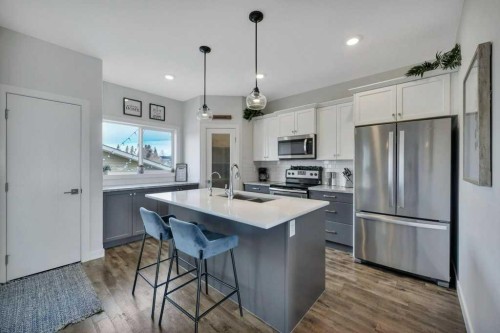 57 Hampton Crescent, Sylvan Lake, AB - Indoor Photo Showing Kitchen With Stainless Steel Kitchen With Double Sink With Upgraded Kitchen