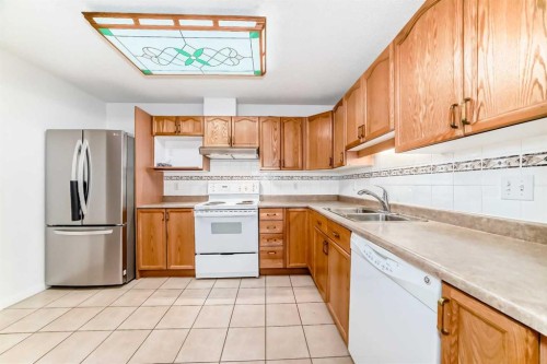 3202 Sienna Park Green Sw, Calgary, AB - Indoor Photo Showing Kitchen With Double Sink