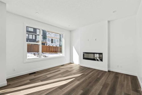 49 Starling Passage Nw, Calgary, AB - Indoor Photo Showing Living Room With Fireplace
