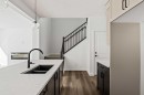 49 Starling Passage Nw, Calgary, AB  - Indoor Photo Showing Kitchen With Double Sink 