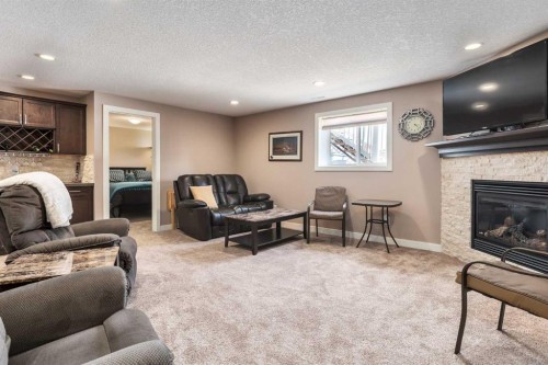 912 Riverside Drive Nw, High River, AB - Indoor Photo Showing Living Room With Fireplace