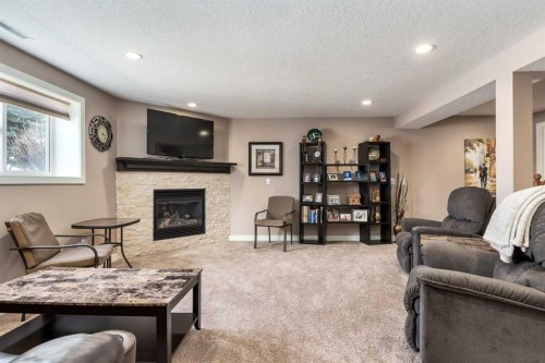 912 Riverside Drive Nw, High River, AB - Indoor Photo Showing Living Room With Fireplace