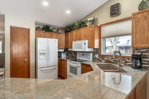 912 Riverside Drive Nw, High River, AB - Indoor Photo Showing Kitchen With Double Sink