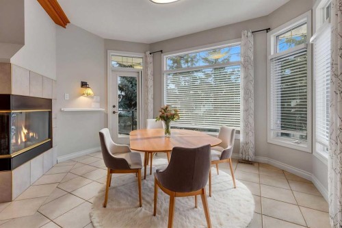 52 Sandstone Ridge Crescent, Okotoks, AB - Indoor Photo Showing Dining Room With Fireplace