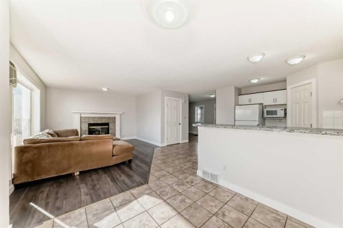 57 Cimarron Meadows Crescent, Okotoks, AB - Indoor Photo Showing Other Room With Fireplace