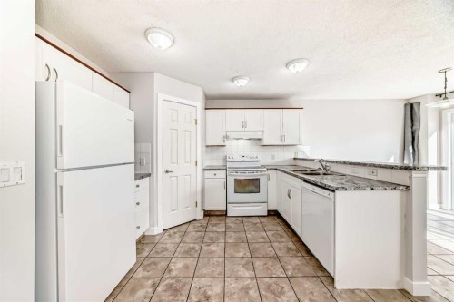 57 Cimarron Meadows Crescent, Okotoks, AB - Indoor Photo Showing Kitchen With Double Sink