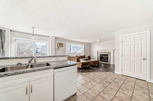 57 Cimarron Meadows Crescent, Okotoks, AB - Indoor Photo Showing Kitchen With Fireplace With Double Sink