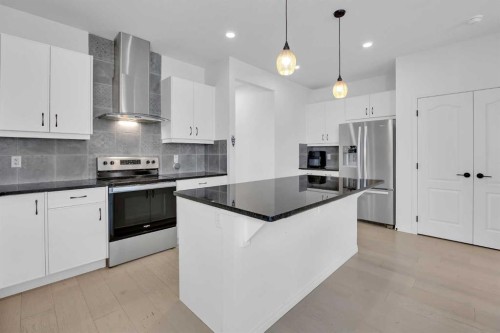 76 Edith Mews Nw, Calgary, AB - Indoor Photo Showing Kitchen With Stainless Steel Kitchen With Upgraded Kitchen