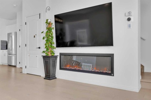 76 Edith Mews Nw, Calgary, AB - Indoor Photo Showing Living Room With Fireplace