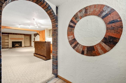 47 Montrose Crescent Ne, Calgary, AB - Indoor Photo Showing Other Room With Fireplace