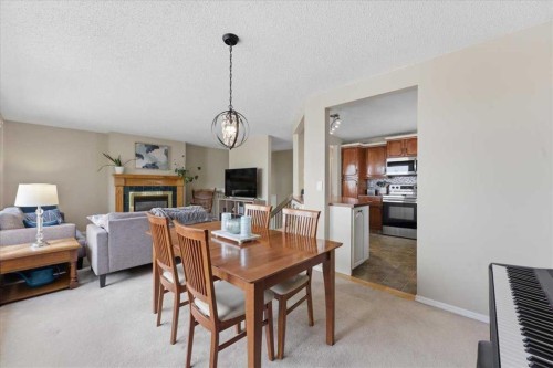 165 Macewan Glen Drive Nw, Calgary, AB - Indoor Photo Showing Dining Room With Fireplace