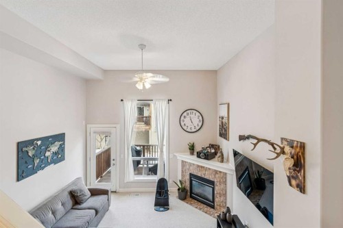 324 Bridlewood Lane Sw, Calgary, AB - Indoor Photo Showing Living Room With Fireplace