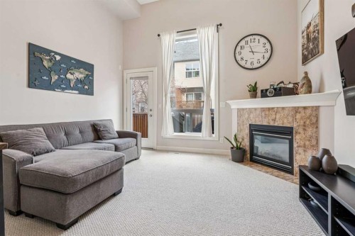 324 Bridlewood Lane Sw, Calgary, AB - Indoor Photo Showing Living Room With Fireplace