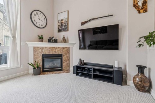 324 Bridlewood Lane Sw, Calgary, AB - Indoor Photo Showing Living Room With Fireplace