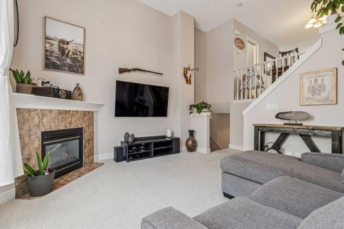 324 Bridlewood Lane Sw, Calgary, AB - Indoor Photo Showing Living Room With Fireplace