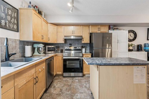 324 Bridlewood Lane Sw, Calgary, AB - Indoor Photo Showing Kitchen With Stainless Steel Kitchen With Double Sink