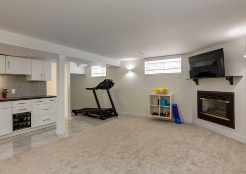 5219 Valiant Drive Nw, Calgary, AB - Indoor Photo Showing Basement With Fireplace
