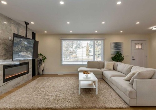 5219 Valiant Drive Nw, Calgary, AB - Indoor Photo Showing Living Room With Fireplace