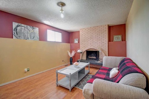 6307 Thornaby Way Nw, Calgary, AB - Indoor Photo Showing Living Room With Fireplace