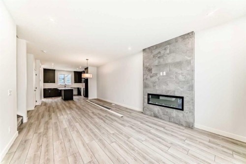 48 Monarch Bend, Rural Rocky View County, AB - Indoor Photo Showing Living Room With Fireplace