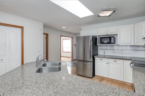 108 Quigley Close, Cochrane, AB - Indoor Photo Showing Kitchen With Double Sink