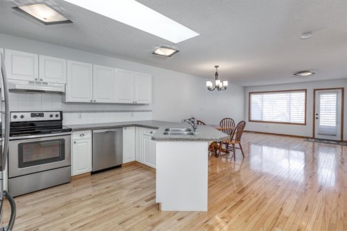 108 Quigley Close, Cochrane, AB - Indoor Photo Showing Kitchen With Stainless Steel Kitchen With Double Sink