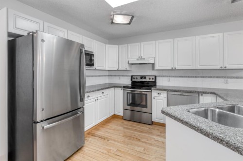108 Quigley Close, Cochrane, AB - Indoor Photo Showing Kitchen With Stainless Steel Kitchen With Double Sink