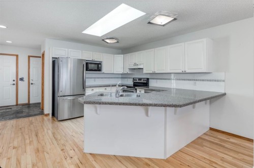 108 Quigley Close, Cochrane, AB - Indoor Photo Showing Kitchen With Stainless Steel Kitchen
