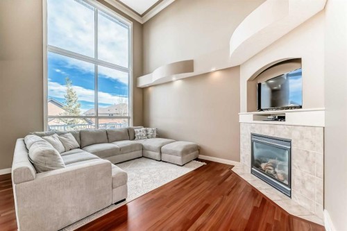 273 Everglade Circle Sw, Calgary, AB - Indoor Photo Showing Living Room With Fireplace