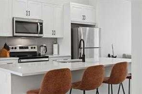 115 Legacy Passage Se, Calgary, AB - Indoor Photo Showing Kitchen With Stainless Steel Kitchen With Upgraded Kitchen