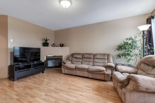 168 Mt Apex Green Se, Calgary, AB - Indoor Photo Showing Living Room With Fireplace
